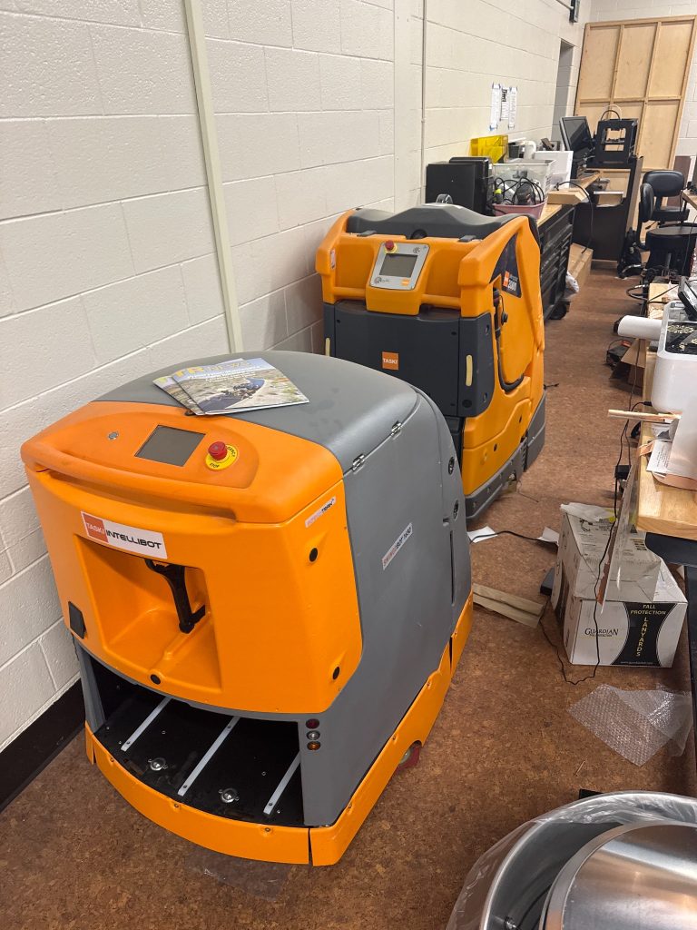 Two autonomous floor-cleaning robots in the DeepTech Lab